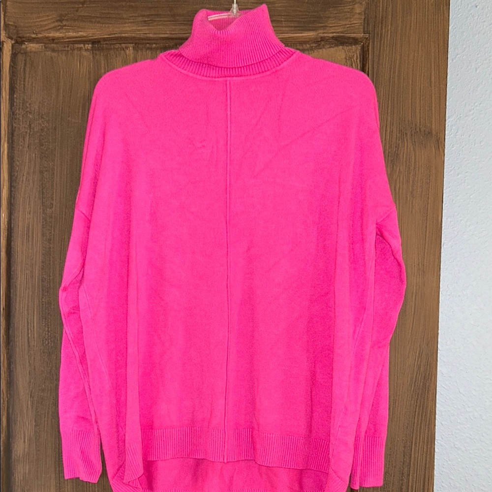 Vibrant pink turtle neck sweater.